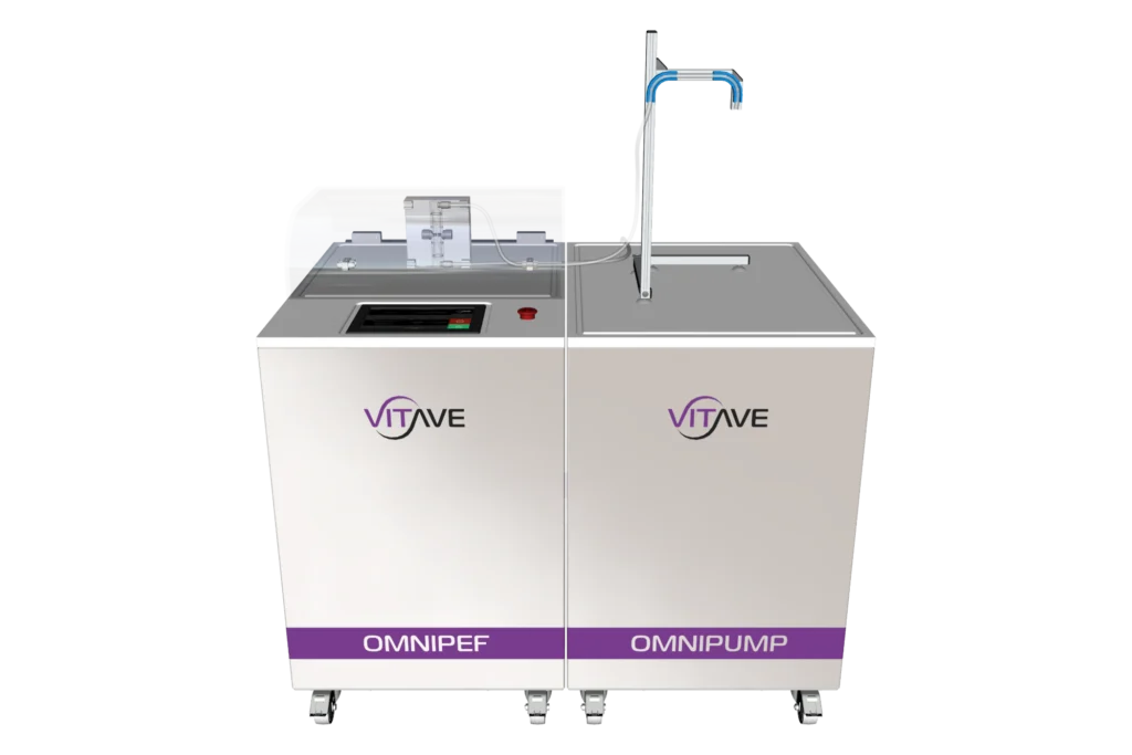 OmniPEF LAB and OmniPump side by side, both white cabinets on castors, the OmniPEF hood over its treatment chamber and the OmniPump outlet arm on its post.