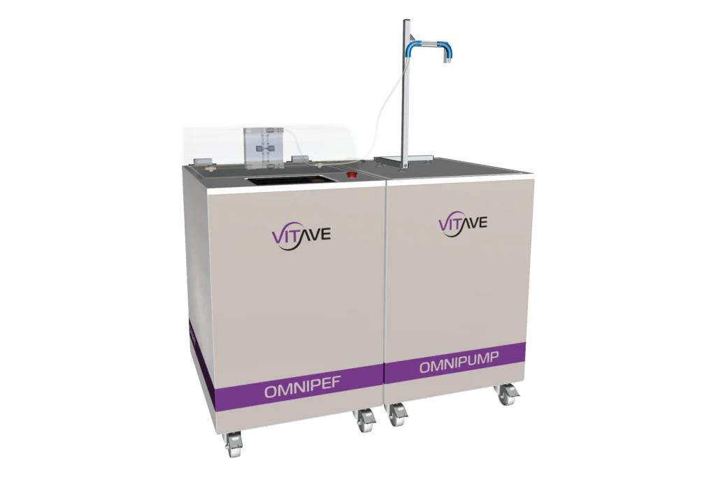 OmniPEF LAB and OmniPump side by side, both white cabinets on castors, the OmniPEF hood over its treatment chamber and the OmniPump outlet arm on its post.